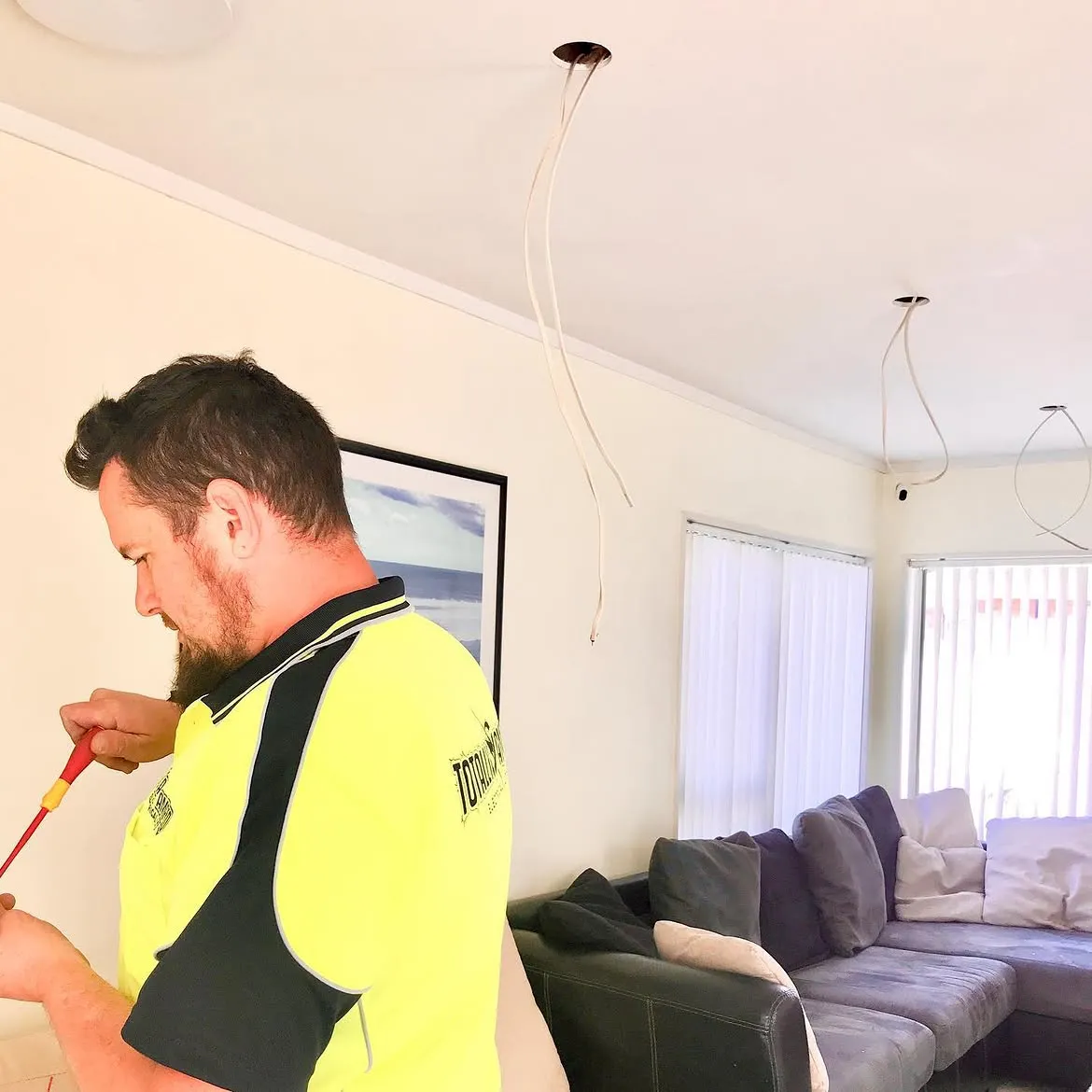 Totally Amped Electrical electrician wiring pendant lights in an Auckland living room